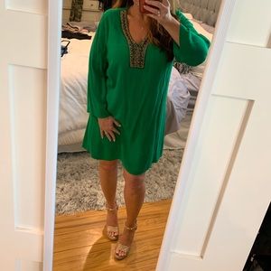 Woman’s flowing green dress with beading